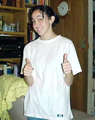 Hay Hay! Thats me in my livingroom type place. I had just dyed my hair black. Thats Daniels shirt.. And that chair behind me is my mommys chair.. yah...